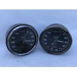 Two 0-120mph Smiths black faced chronometric speedometers.