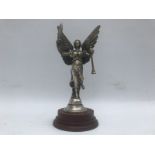 An Angel of Peace Victory mascot holding a feather and trumpet, nickel plated on turned wooden