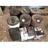 A selection of five gallon oil drums and gallon cans.