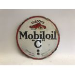 A circular Mobiloil 'C' double sided enamel cabinet/tank indicator, some retouched lettering to