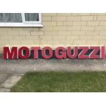 A group of motorcycle showroom letters advertising Moto Guzzi, mounted on two boards for display,