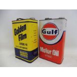 A Gulf Motor Oil gallon can and a Golden Film Superior Lubricants gallon can.