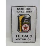 A Texaco Motor Oil rectangular enamel sign with central image depicting oil pouring from a jug, with