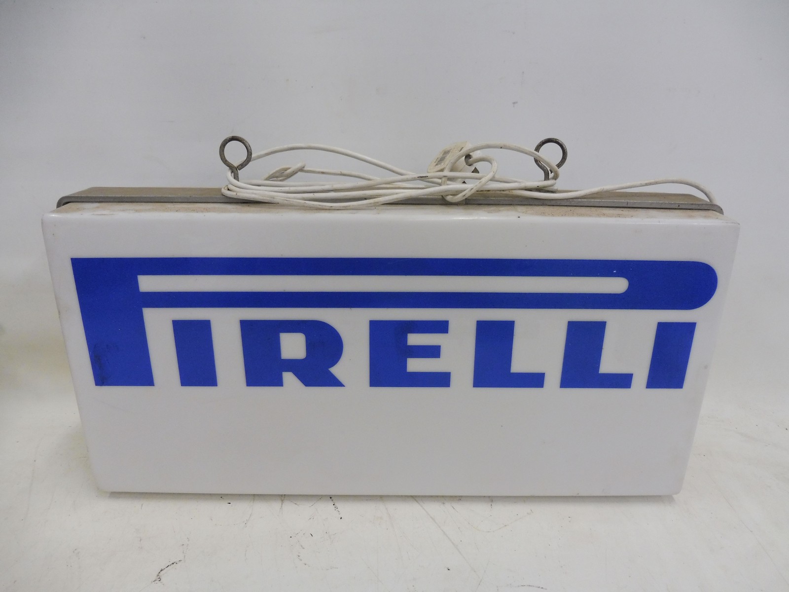 A Pirelli double sided hanging lightbox, 25 1/4" wide x 12" high x 5 3/4" deep.