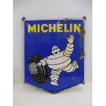 A Michelin pictorial enamel sign depicting Mr. Bibendum rolling a tyre, 26 3/4 x 31 1/2".