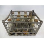 A twelve section oil bottle crate containing a full set of 12 Shell oil bottles.