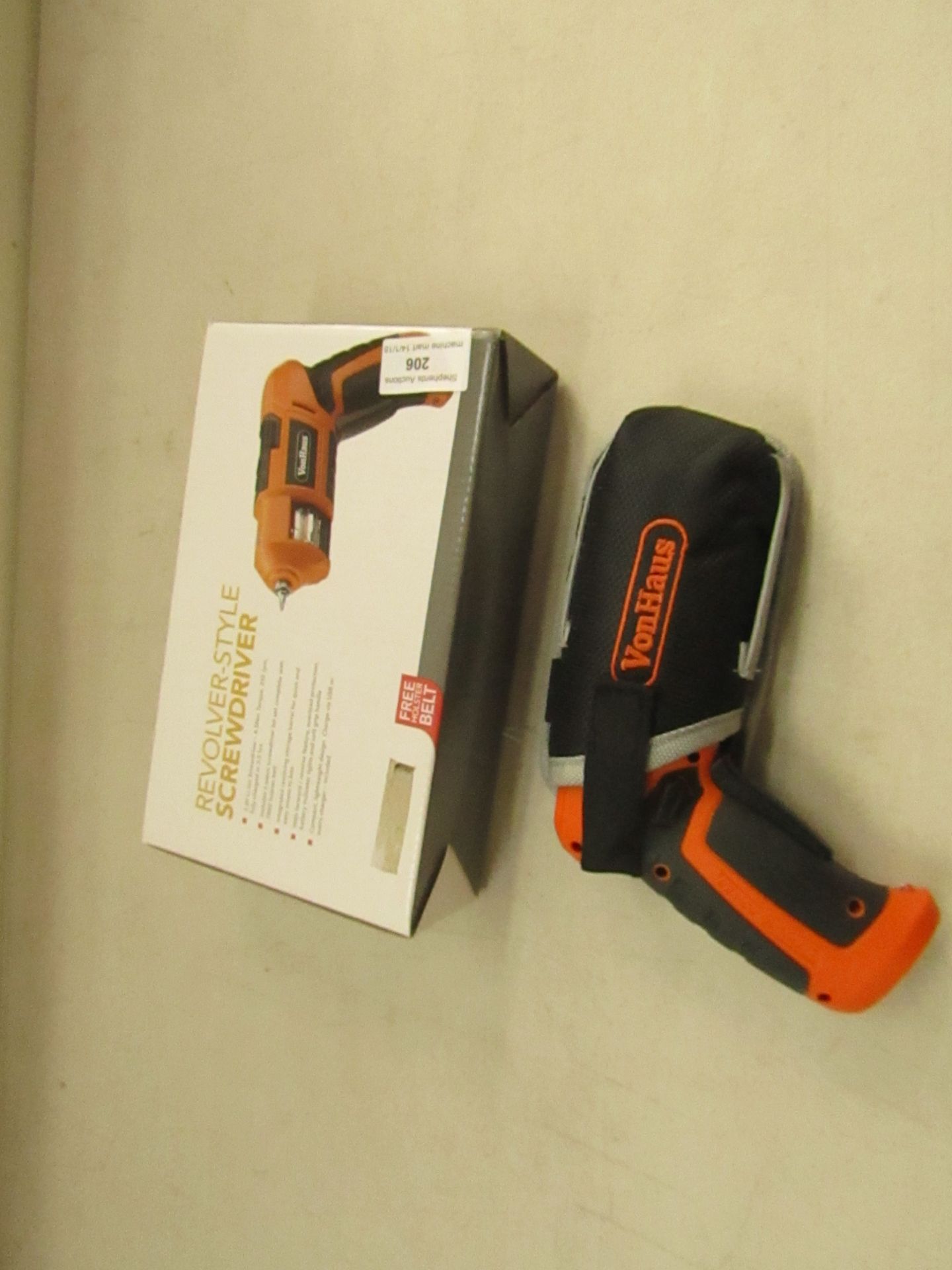 Revolver style screwdriver with holder and charger, tested working and boxed. Please note by bidding