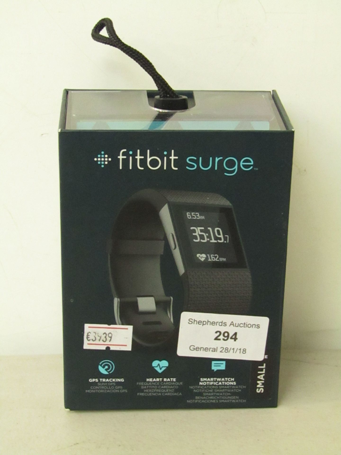 Fitbit Surge, Used with damaged strap, in packaging