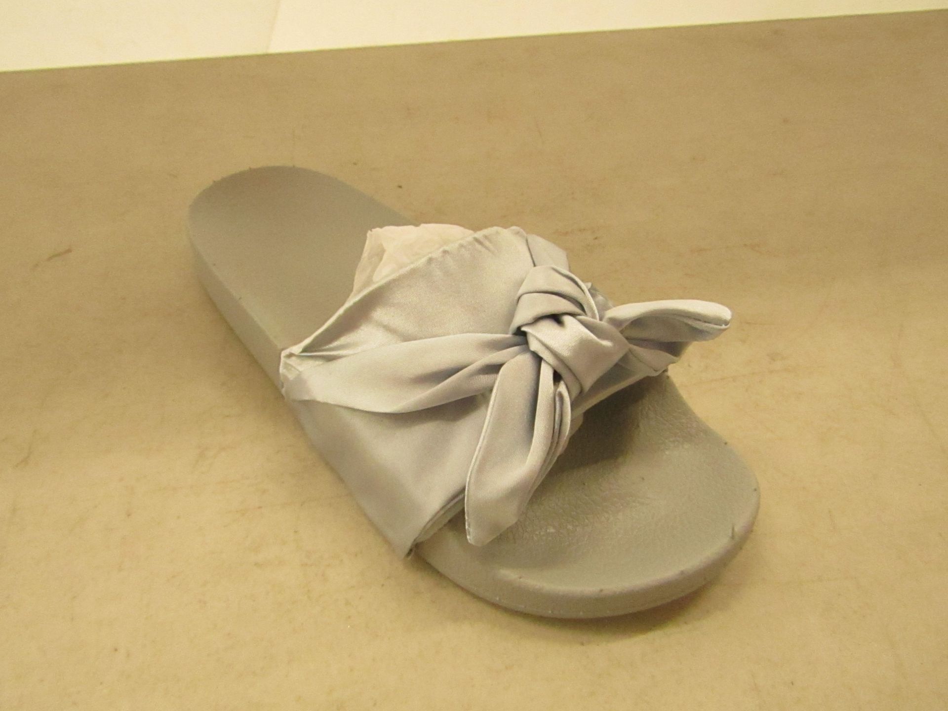 Lady's grey coloured flip flops, size 5, new and packaged.