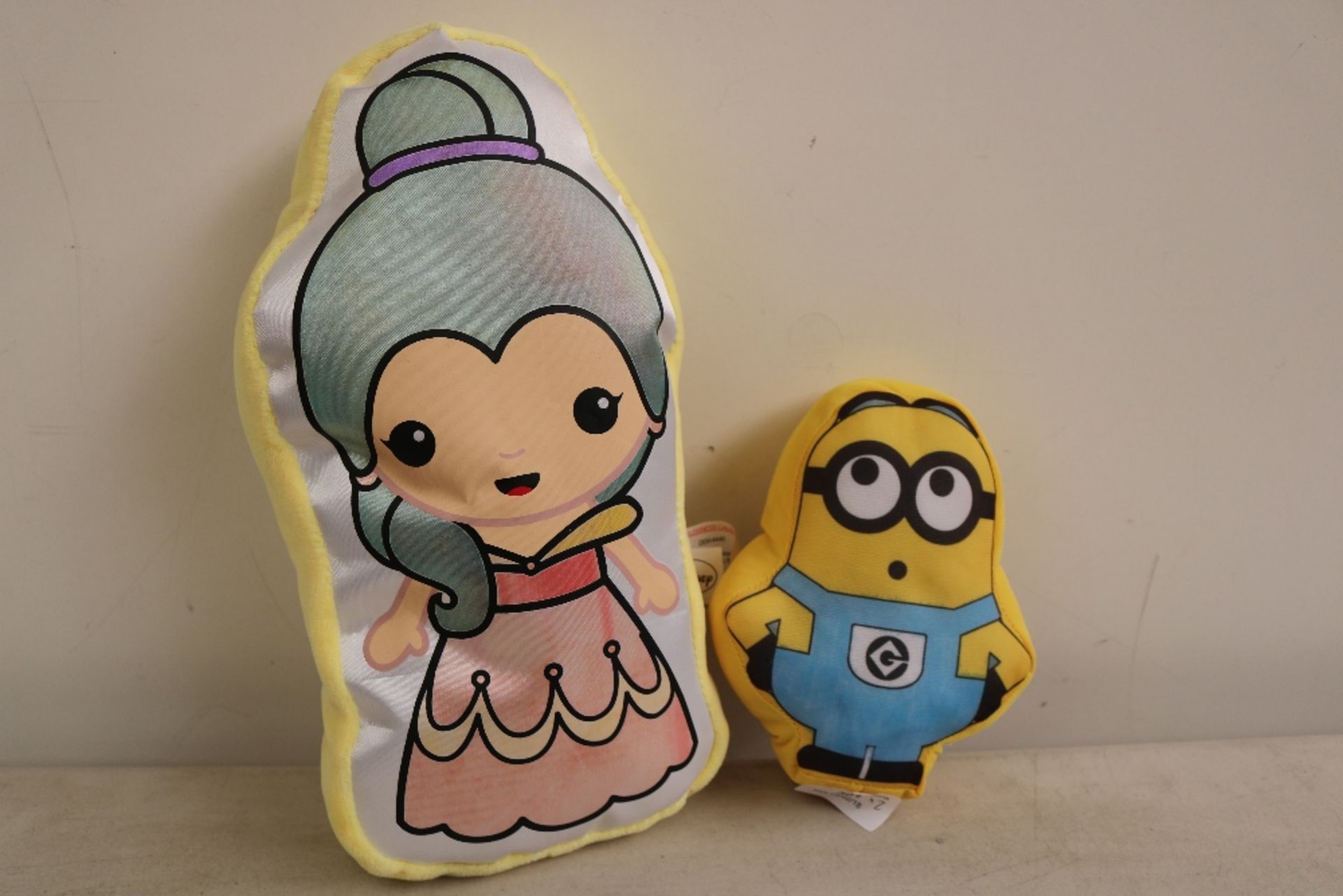 2x Plush toys (1 minion and the other Disney princess), no damage.