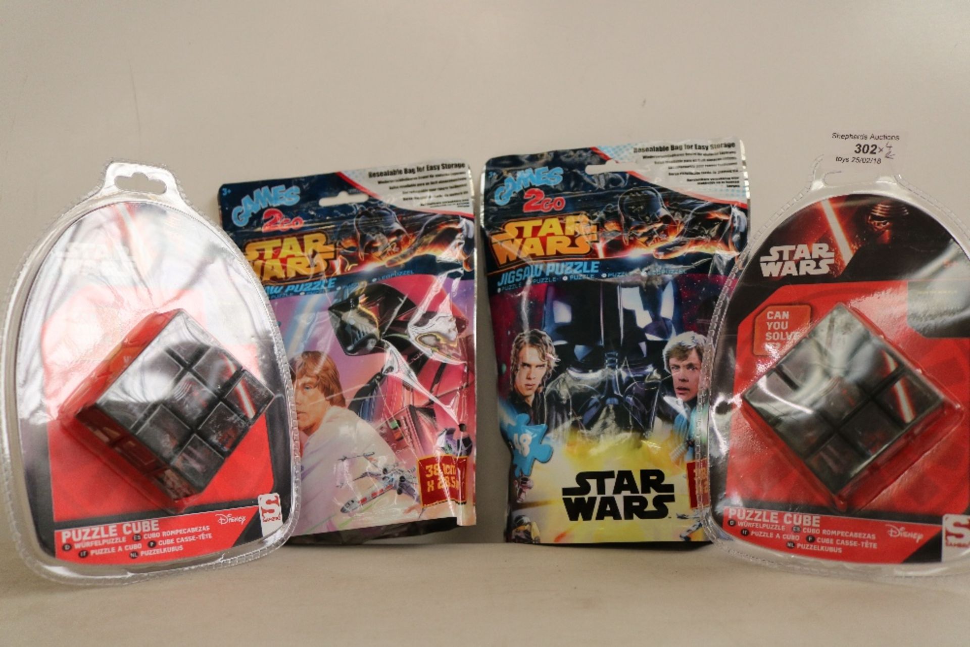 4x Items being.   - 2x Disney Star Wars puzzle cube, new and factory sealed in packaging.  - 2x Star