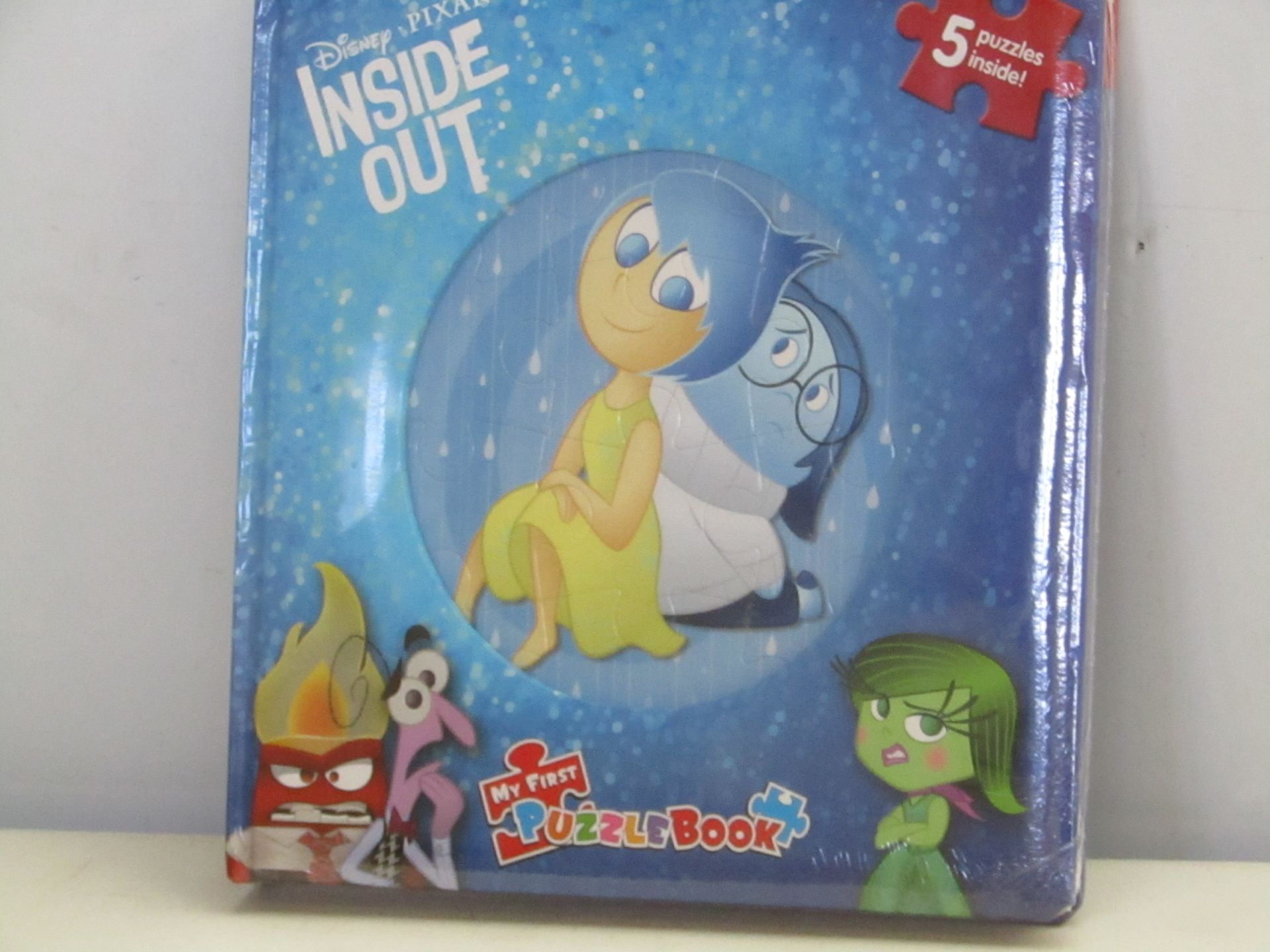 Box containing 12x Disney Pixar Inside Out Puzzle Books. New and boxed.