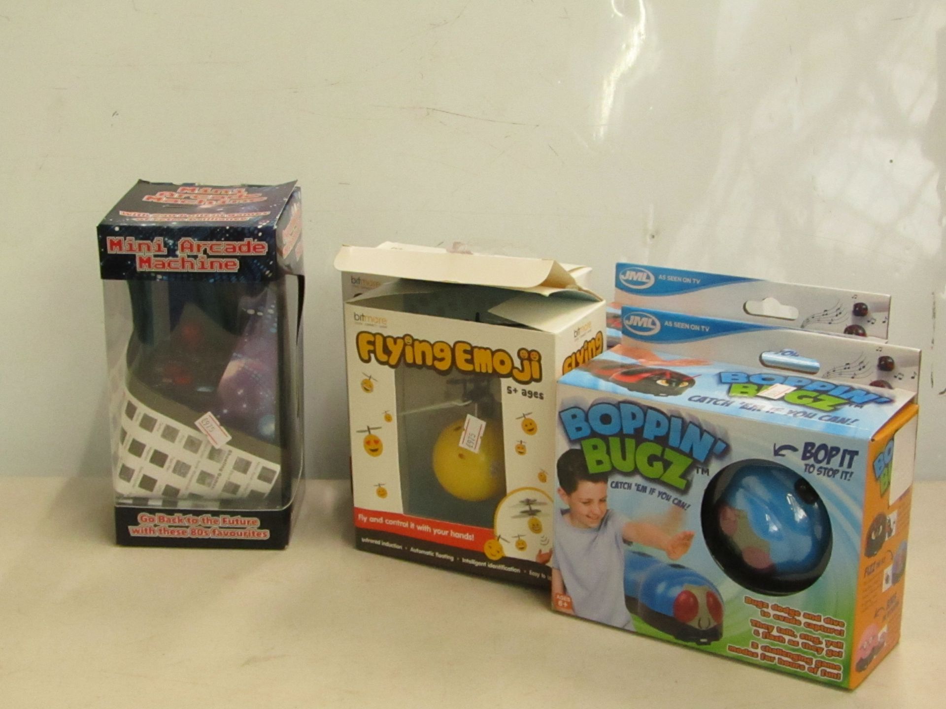 5 items being 2 x Bitmore Flying Emoji's, 2 x Boppin Bugs packaged & Mini Arcade Machine packaged