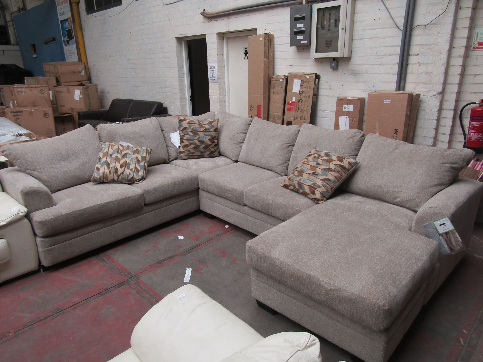 Costco Sectional Sofa with 3 Accent cushions, item is new but has a cut on the back of one of the