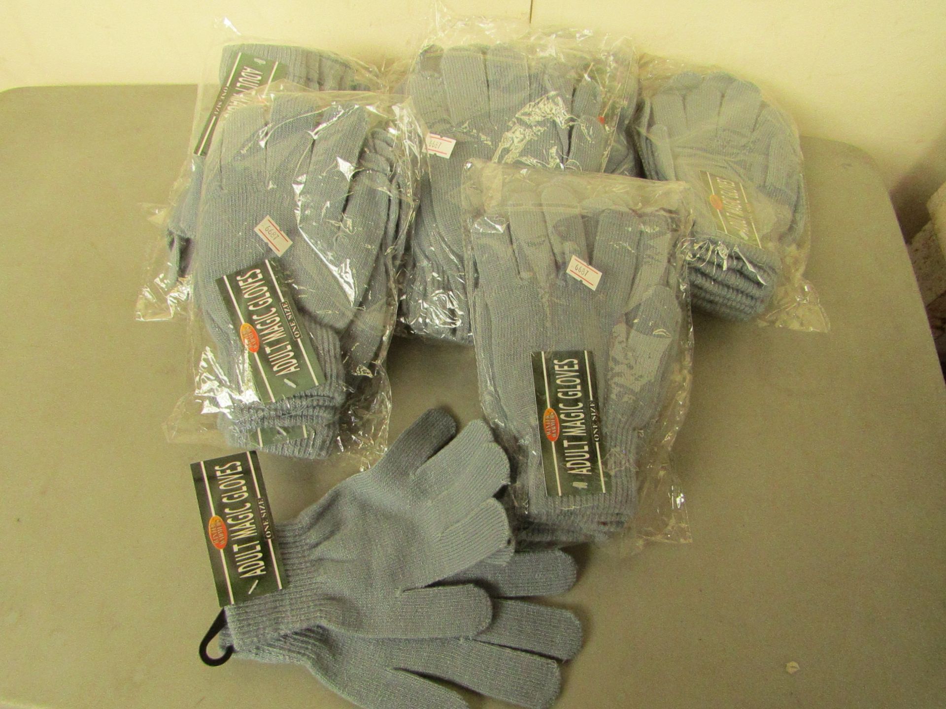 40 X Pairs of adult magic gloves all grey all new in packaging