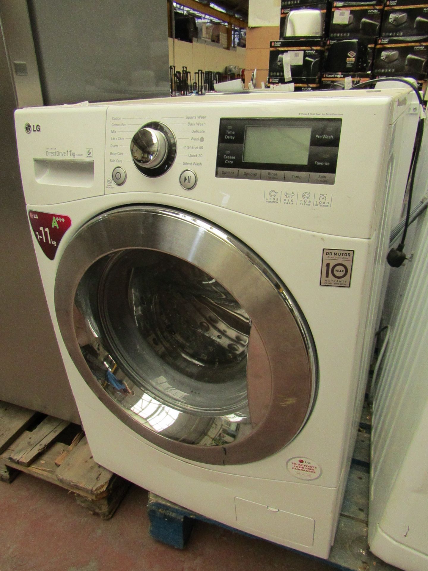 LG F1495KD Inverter Direct Drive 11kg washing machine, has clear damage to the door and a few dents.