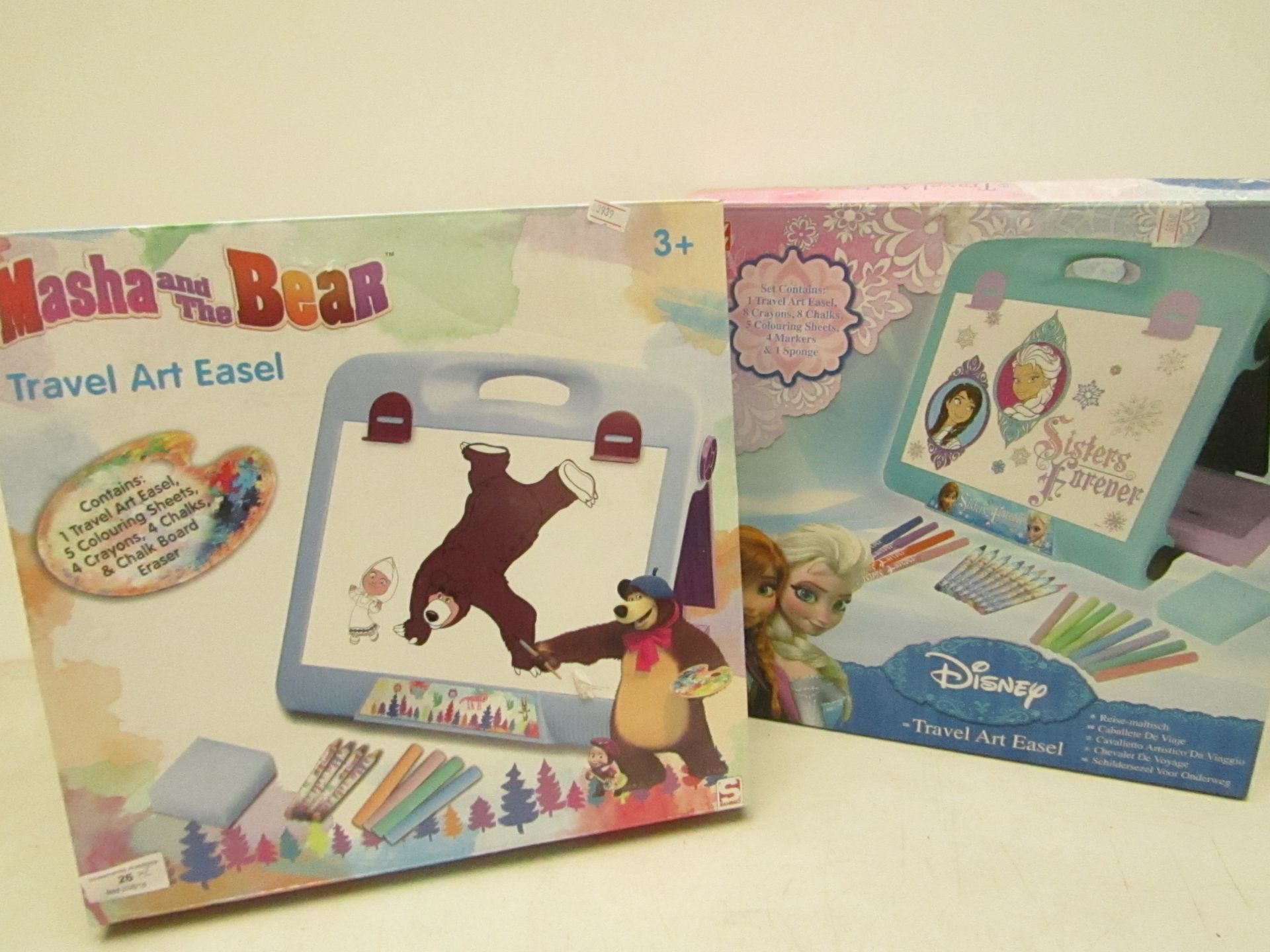 2x Items being.  - Masha and Bear travel art easel, boxed.  - Disney Frozen art easel, boxed.