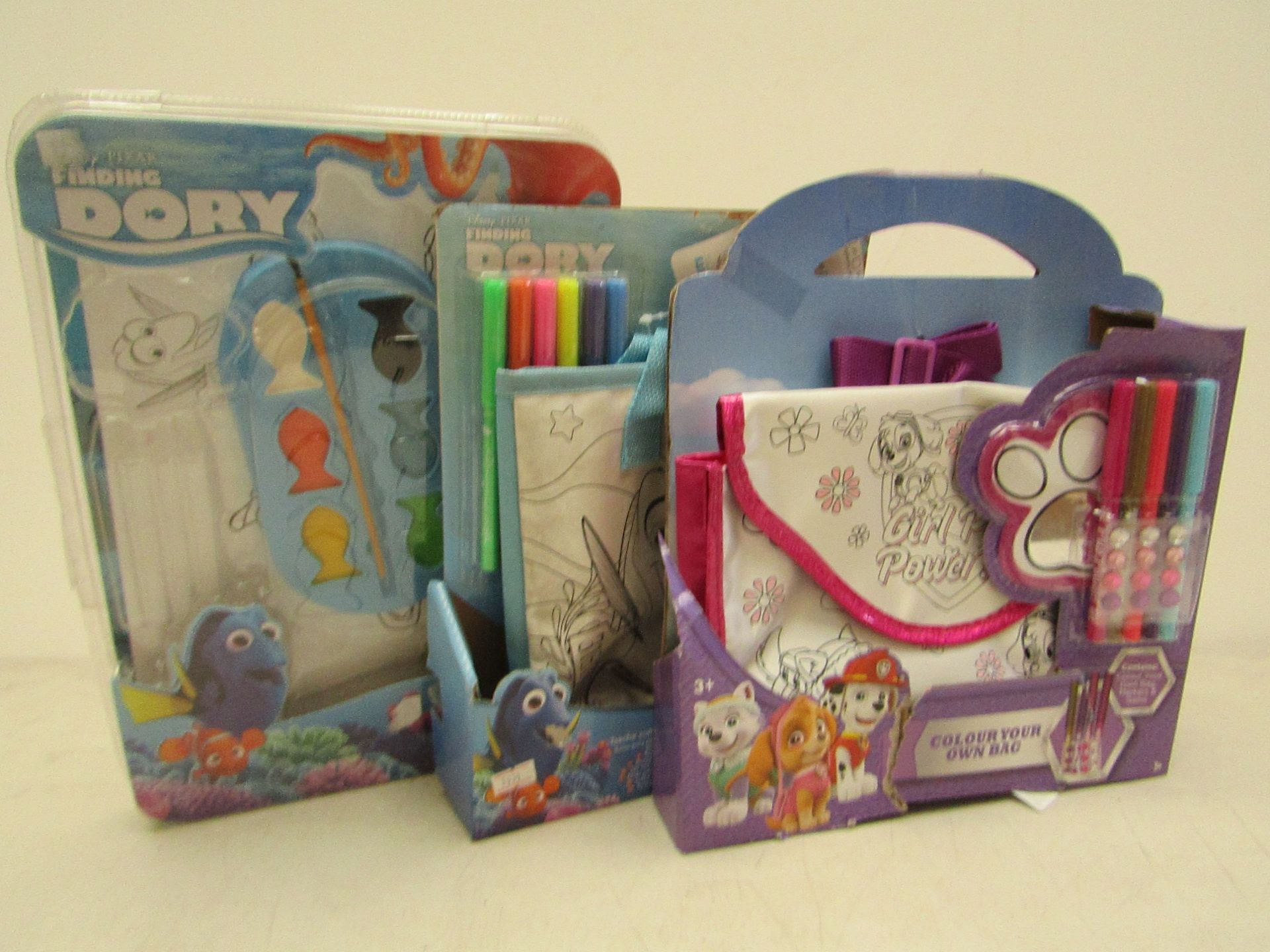 3x Items being.  - 2x Colour your own bag sets, boxed.  - Colouring set, new and packaged.