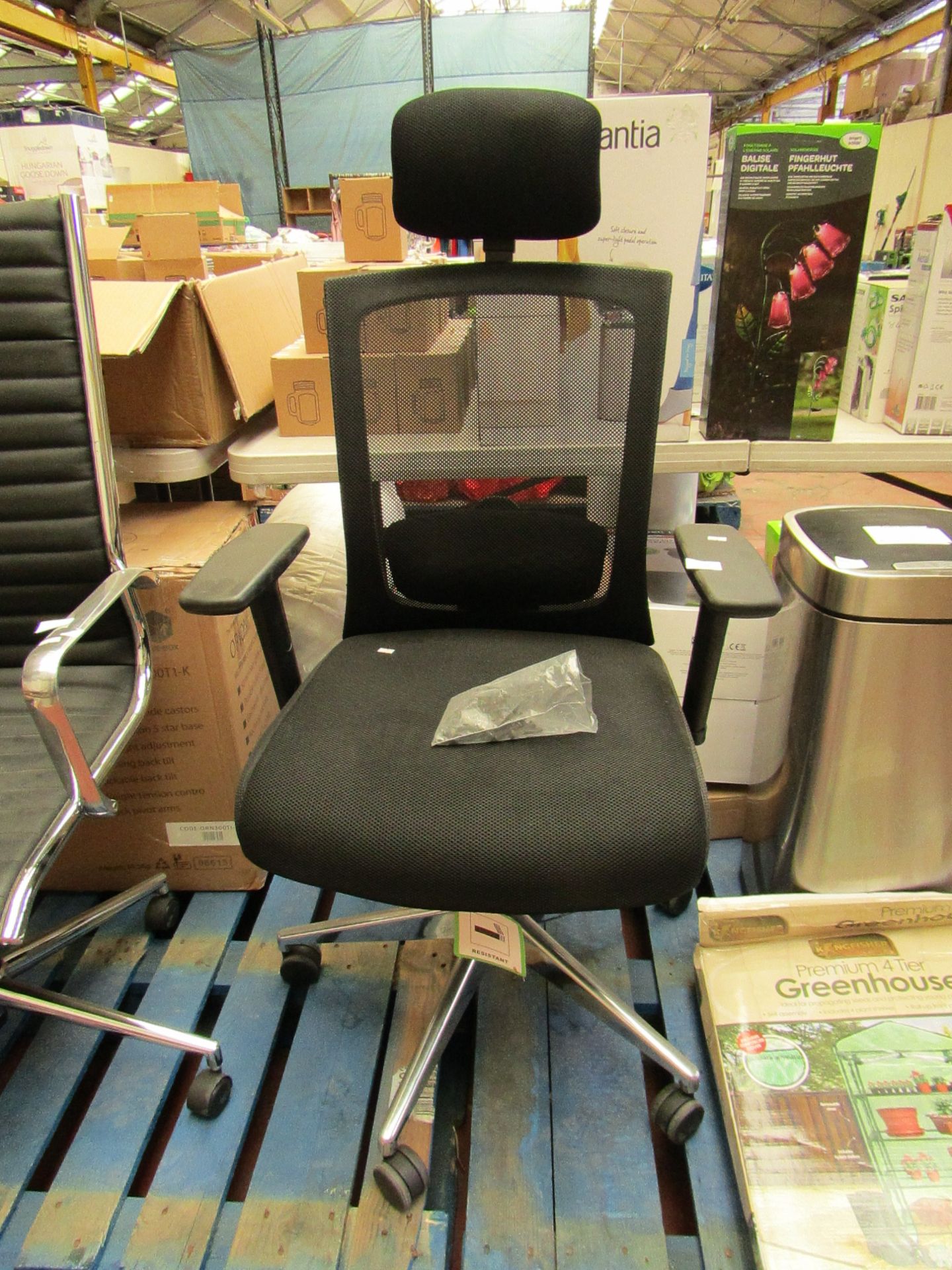 Lightweight fabric office chair with headrest, missing one wheel.