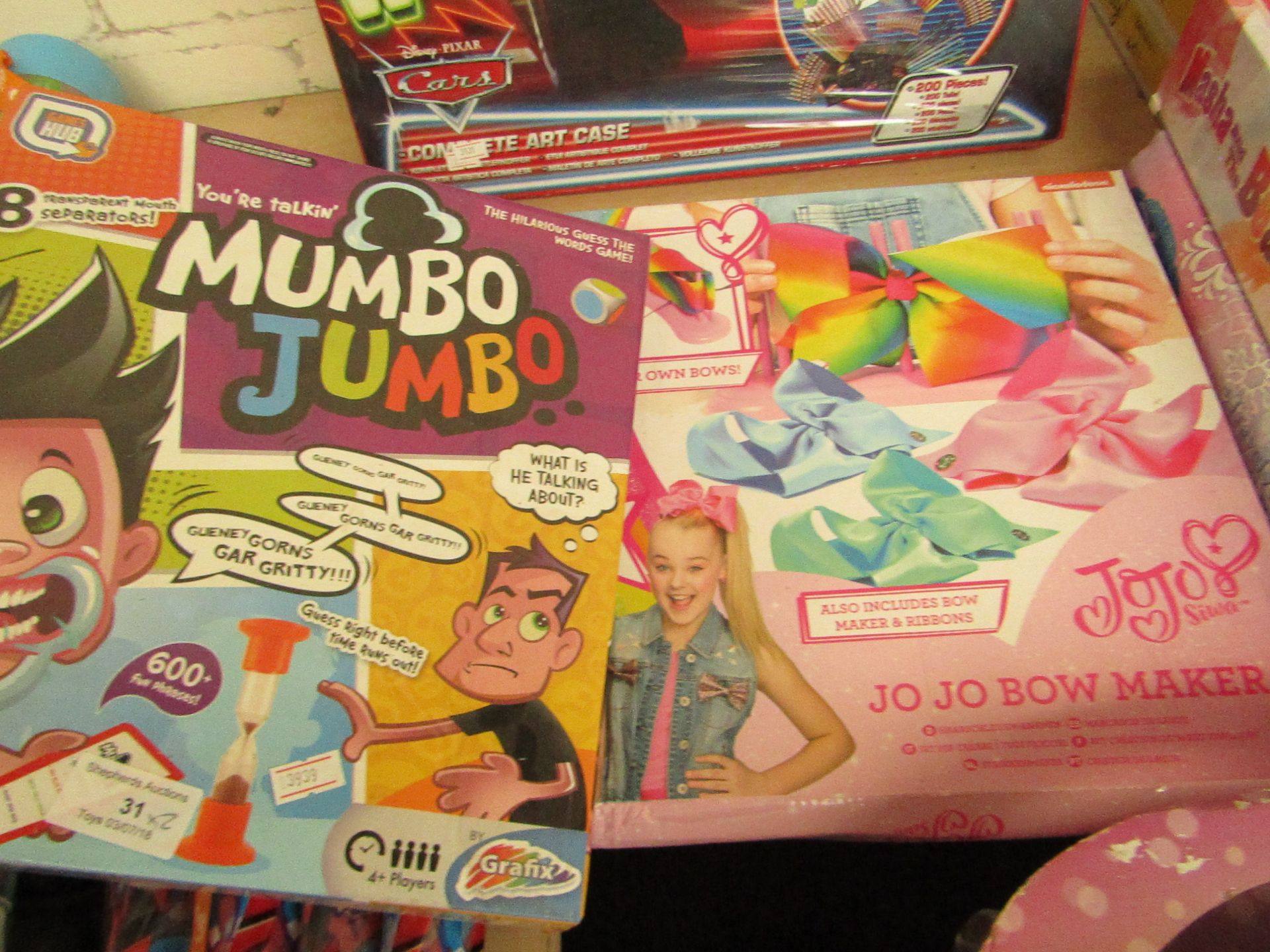 2x Items being.   - Mumbo Jumbo card / board game, boxed.   - Jojo Siwa bow making kit, boxed.