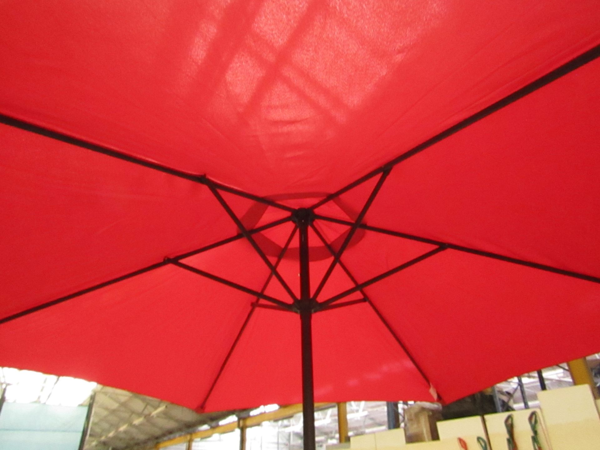 Tall Red colour parasol with crank handle and Parasol base. Base has a crack but this does not