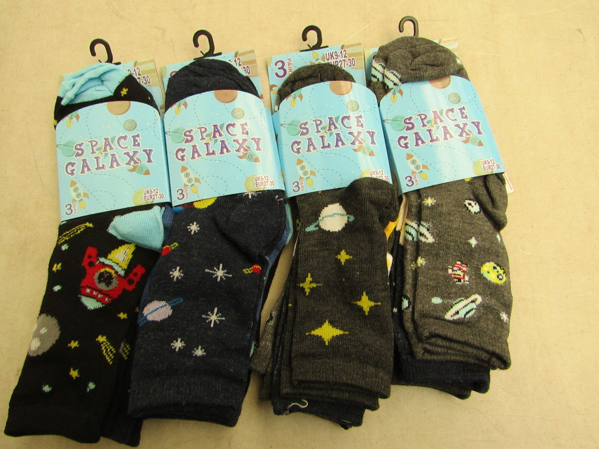 12 X Pairs of childrens socks space galaxy themed size 9-12 all new in packaging