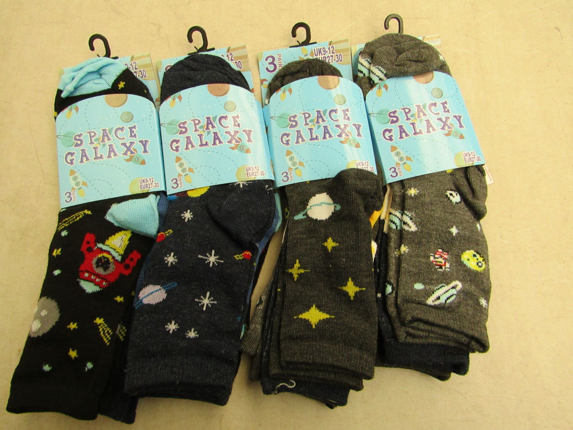 12 X Pairs of childrens socks space galaxy themed size 9-12 all new in packaging