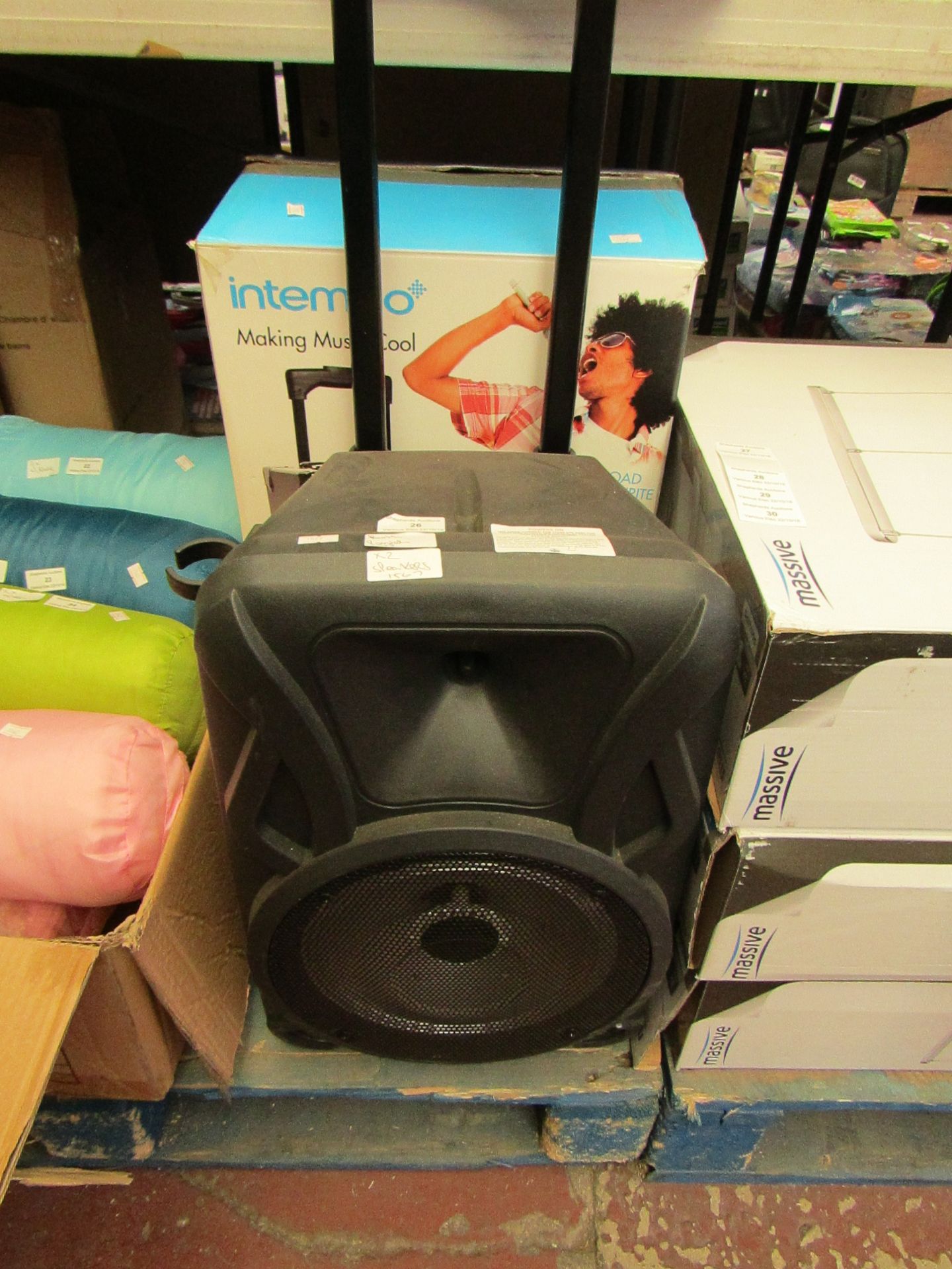 2x Speakers being; Intempo karaoke speaker and Large speaker with handle. Both power on and one is