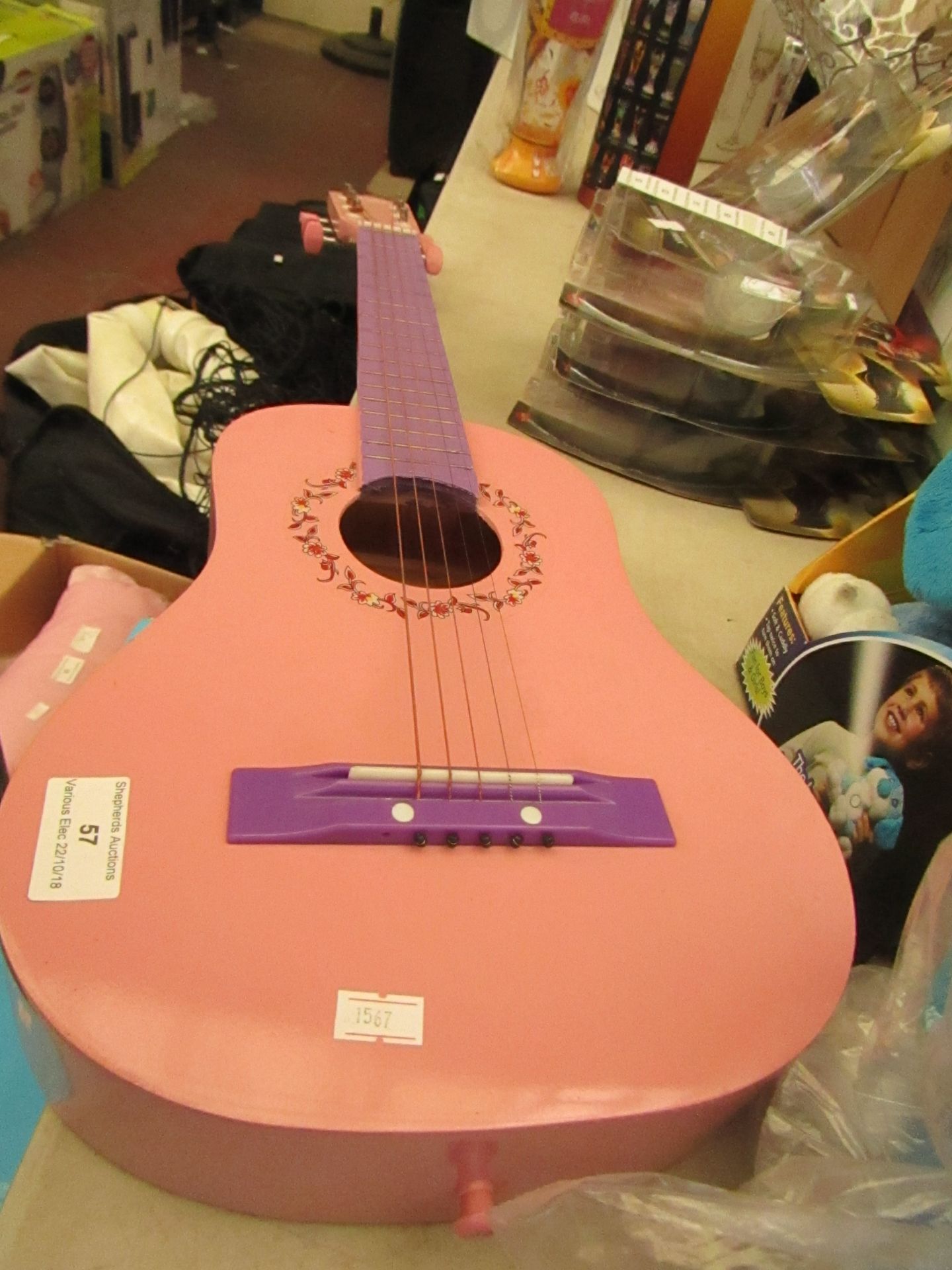 Small pink colour guitar with 5 strings (missing a 6th string) has some minor scuffs.