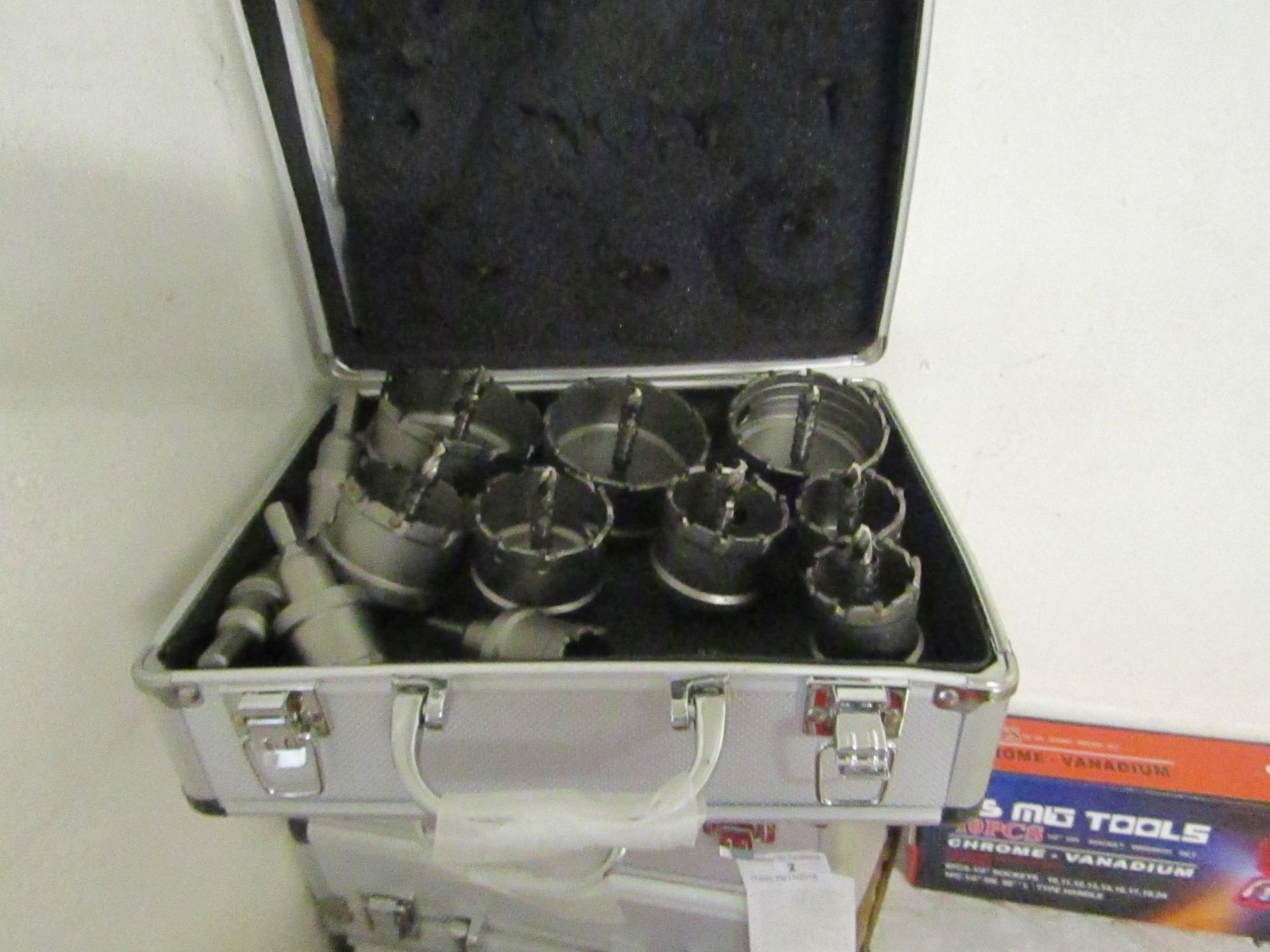 12 piece Hole saw set all with arbours, new in metal effect carry box.