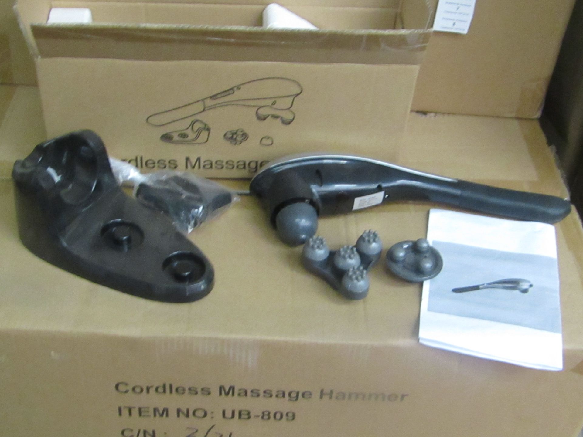 Cordless handheld massage hammer with various head attachments. New & boxed.