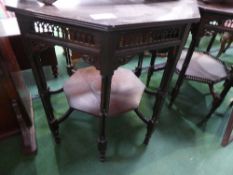 Octagonal ebonised display table with under shelf