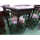 Octagonal ebonised display table with under shelf