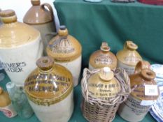 9 various sized salt glazed flagons & 2 glass bottles