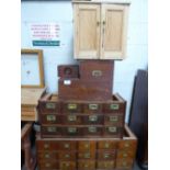 A large qty of wooden filing drawers, 2 metal filing cabinets, parts of a wooden writing table & qty