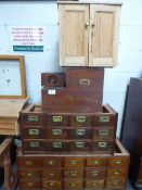 A large qty of wooden filing drawers, 2 metal filing cabinets, parts of a wooden writing table & qty