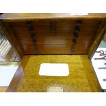 Mahogany portable cabinet with 7 drawers containing various Engineering items