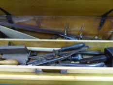 Pine carpenter's box containing various hand tools, bow saws, chisels etc