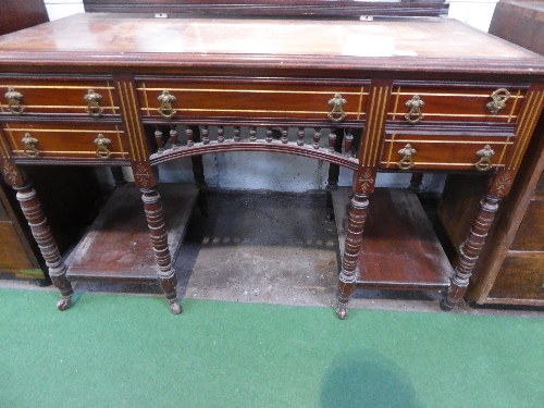 Mahogany sideboard on 8 turned legs to castors with centre drawer flanked by 2 smaller drawers,