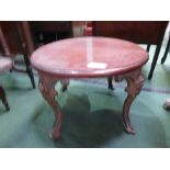 Low circular coffee table with small decorated cast iron legs