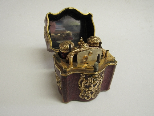 Early 19th Century miniature travelling set with gold metal decorations on red leather covered case,