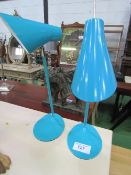 2 light blue coloured desk lamps