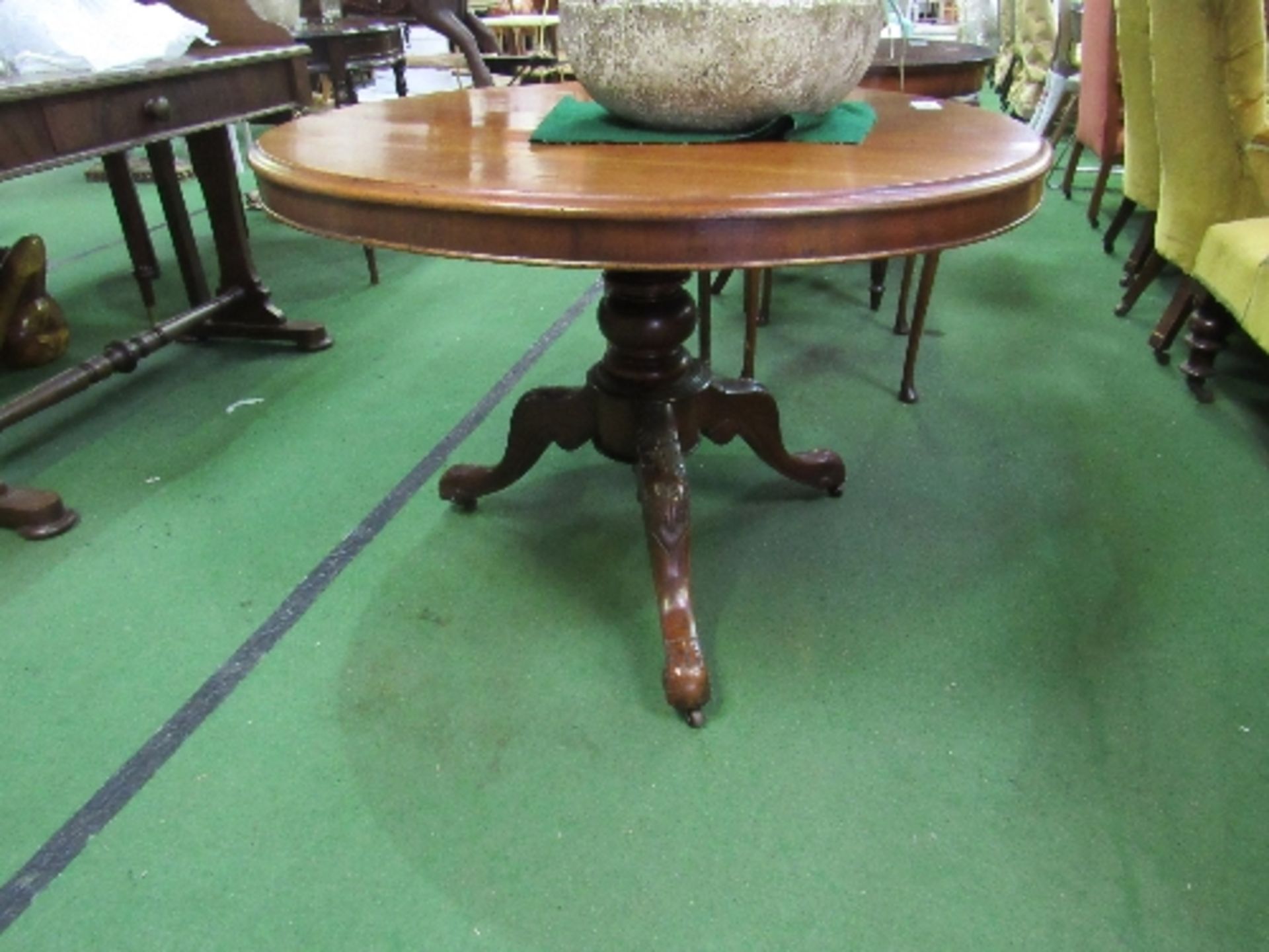 Mahogany circular tilt-top table on ornate pedestal to 3 legs on casters, 40" diameter x 28" high