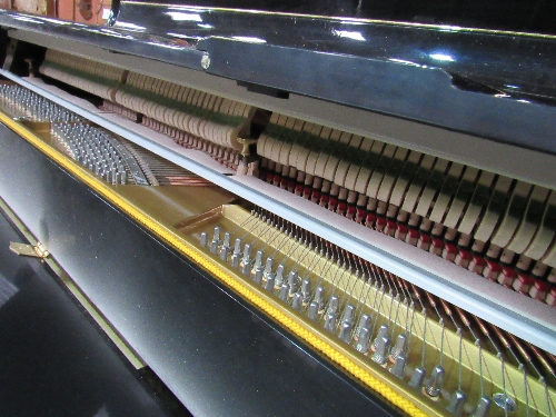 A Hemmington upright piano in gloss black finish with dark brown embellishments, on casters. Frame - Image 4 of 4