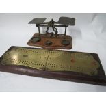 A set of postal scales & a wood mounted brass cribbage board