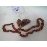 A 72gms amber necklace & 62gms of raw amber