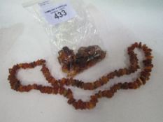 A 72gms amber necklace & 62gms of raw amber