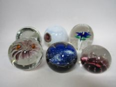 A collection of 6 paperweights including Caithness