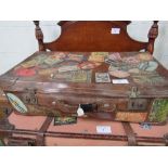 Large vintage leather travel case covered with many international travel labels