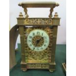 A pretty brass cased enamel face carriage clock with filigree decoration